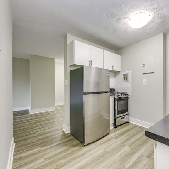 a kitchen with a stainless steel refrigerator and oven.