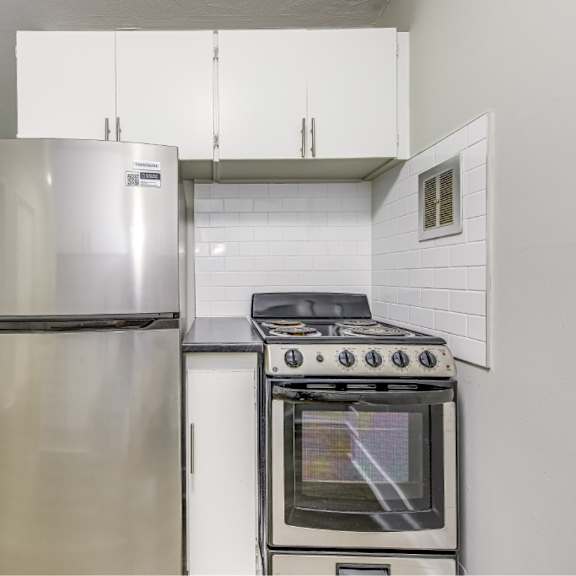 a modern kitchen with a stainless steel refrigerator and oven.