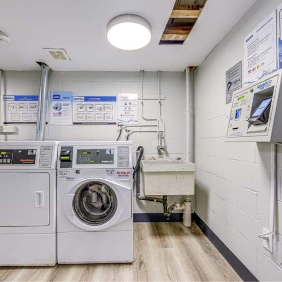 a laundry room with washers and dryers.
