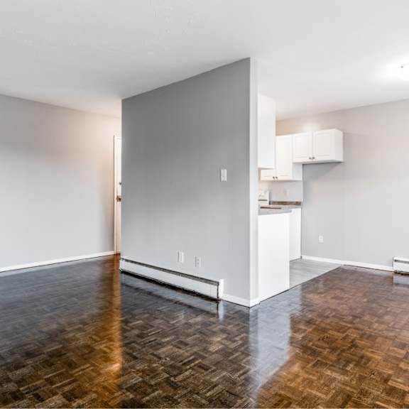 a room with a wooden floor and white walls.