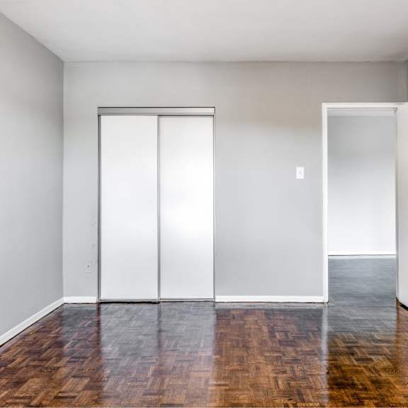a room with a sliding door and a wooden floor.