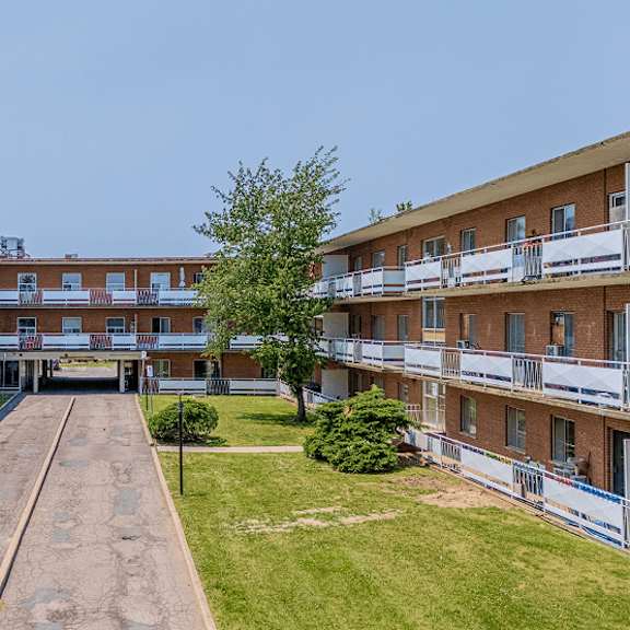 a long building with a balcony on the second floor.