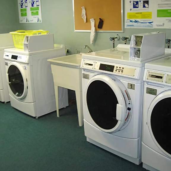 a row of washing machines in a laundromat.