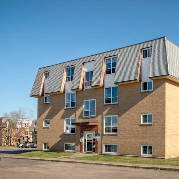 a modern building with a combination of brick and siding exterior.