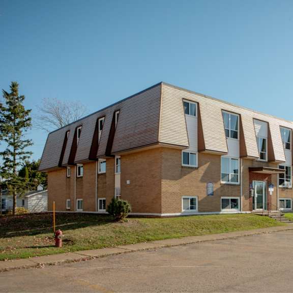 a long building with a lot of windows and doors.