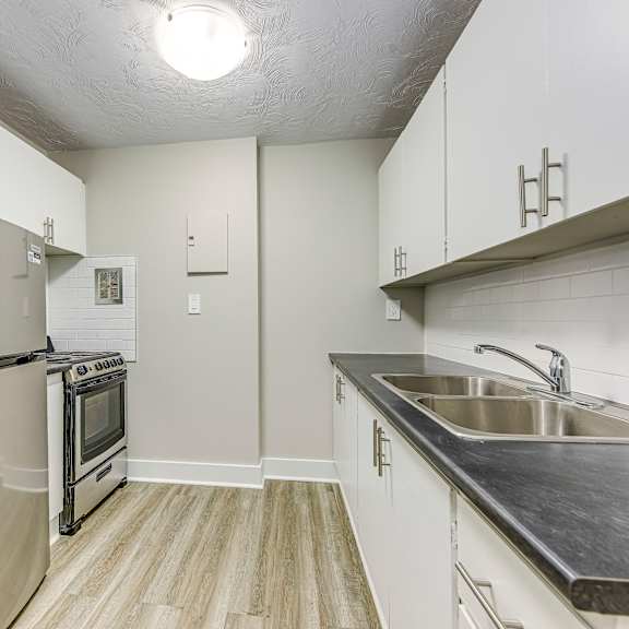 a kitchen with a stainless steel refrigerator and oven.