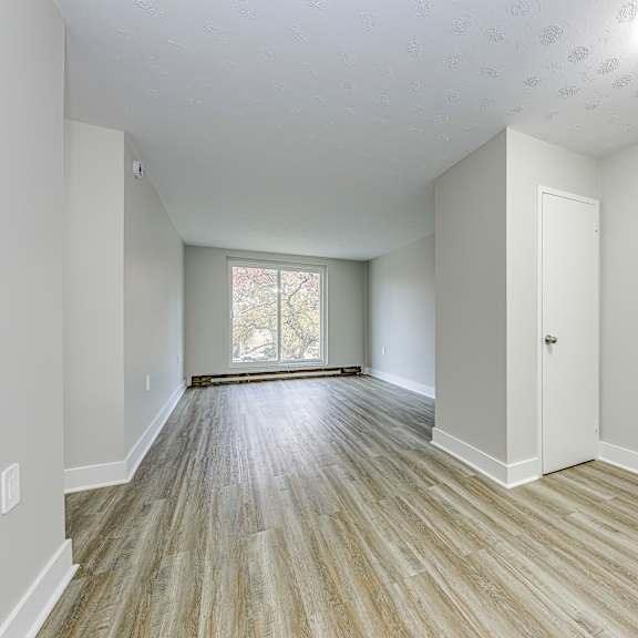 a room with wooden flooring and a window.