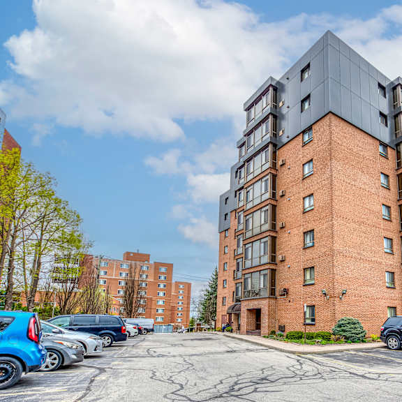 a large brick building with a parking lot in front of it.