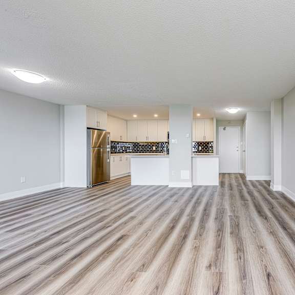 a room with wooden flooring and white walls.