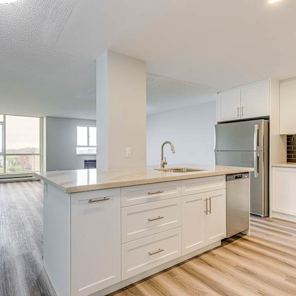 a kitchen with white cabinets and a sink.