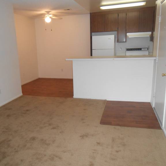 a kitchen area with white appliances and wooden cabinets.