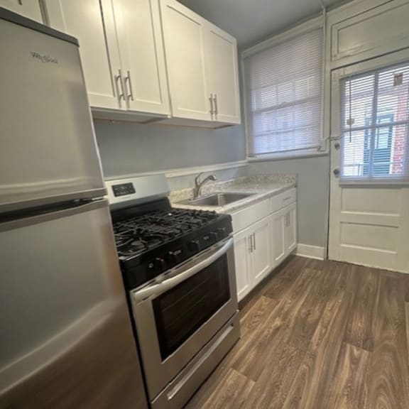 a kitchen with white appliances and cabinets.