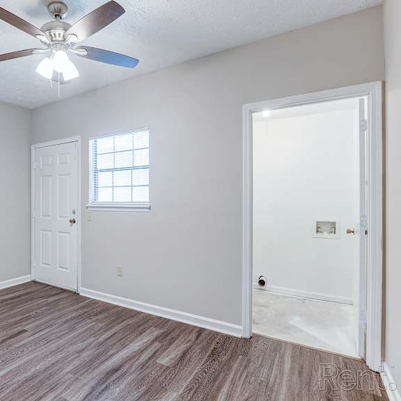 a room with a ceiling fan and a window.