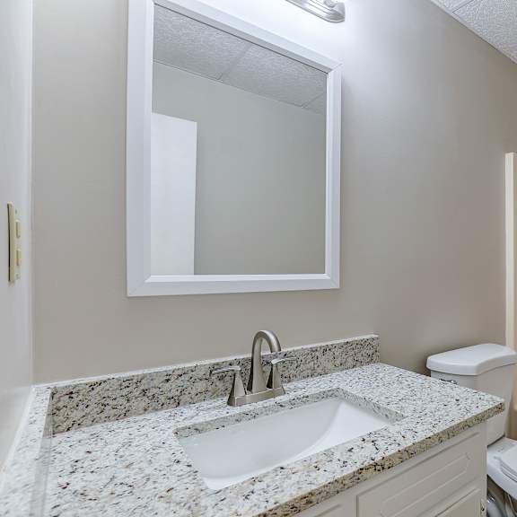a bathroom with a sink, toilet, and bathtub.