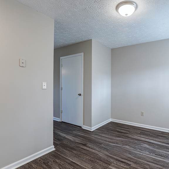 a room with a white door and a window with a white frame.
