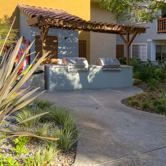 a patio area with a table and chairs.