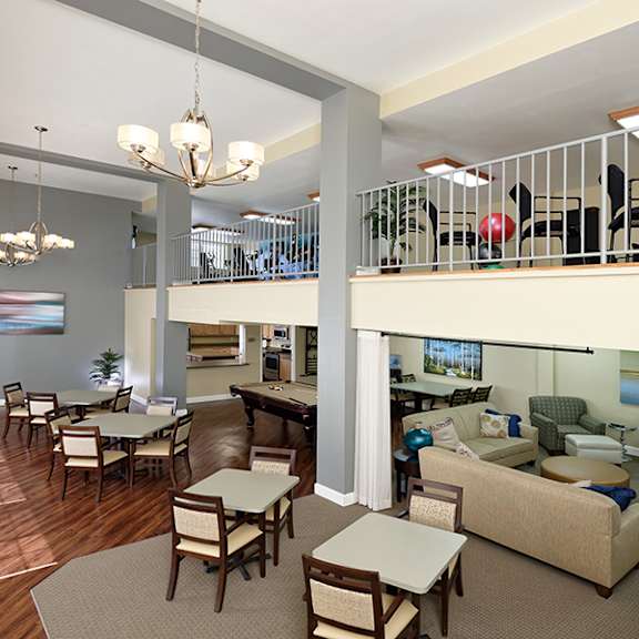 a large open living room with a balcony and a dining area.