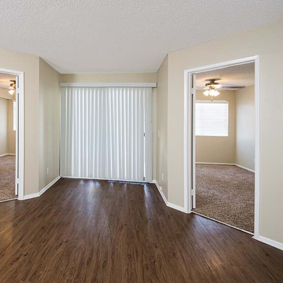 a room with wooden floors and white walls.