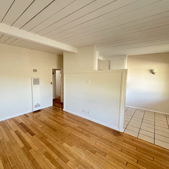 a room with wooden floors and white walls.