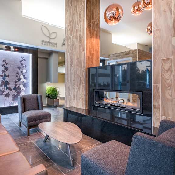 a modern living room with a fireplace and a copper-colored sofa.