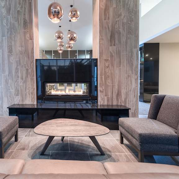 a modern living room with a fireplace and comfortable seating.