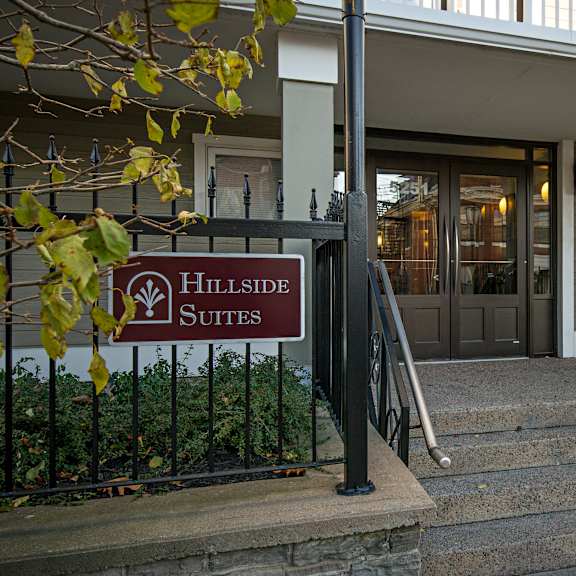 hillside suites sign in front of a building entrance.