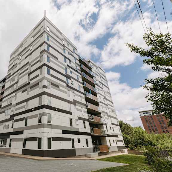 a tall building with a lot of windows and balconies.
