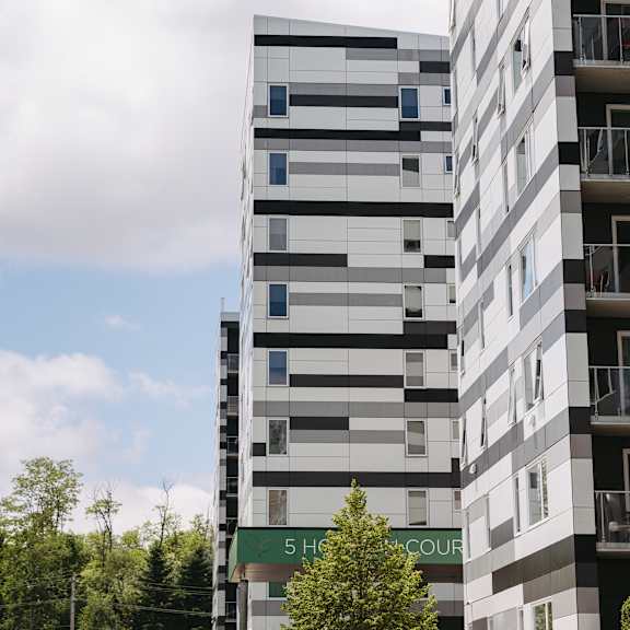 a tall building with a green sign that says "5 hsbc court".
