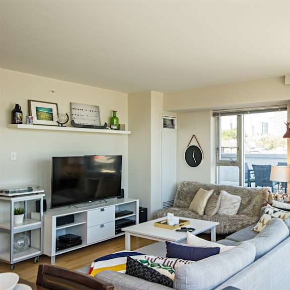 a living room with a grey couch and a television.