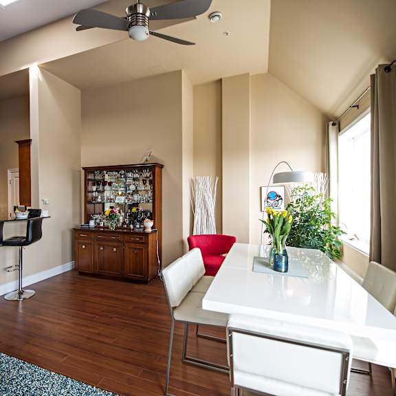 a modern kitchen with a bar area and a dining table.