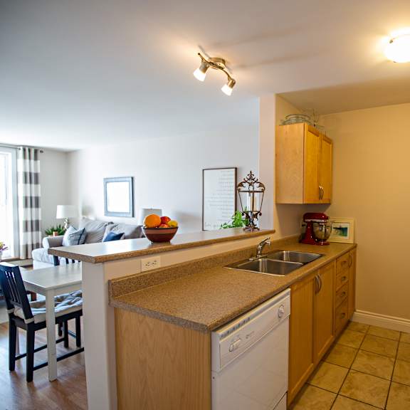 a kitchen with a white fridge and wooden cabinets.