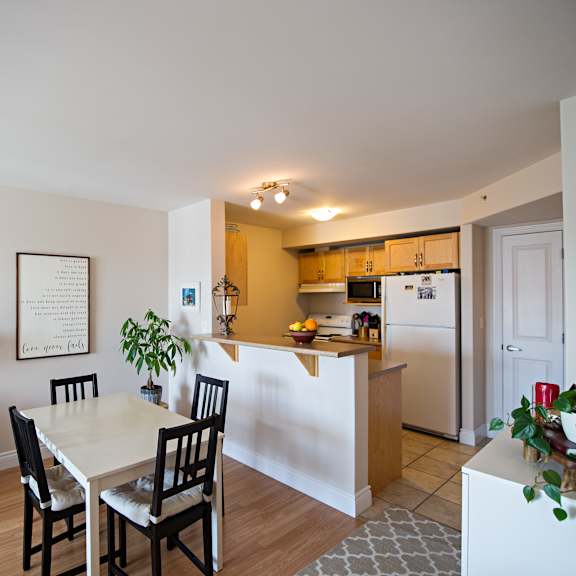 a dining room with a table and chairs is shown.