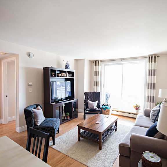 a living room with a couch, chair, and television.