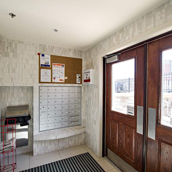 a white wall with a calendar and a red cart in front of it.