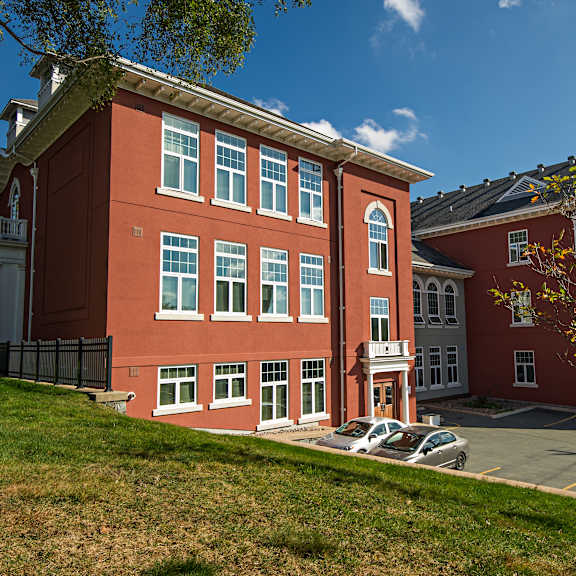 a red building with a tree in front of it.