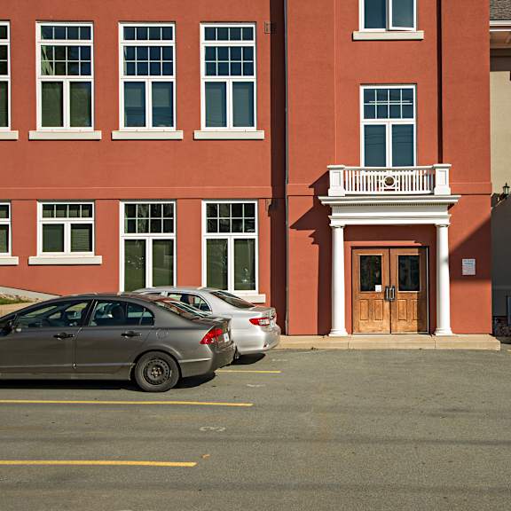 a red building with a white door and a balcony.