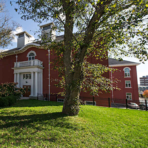 a red building with a white door and windows.