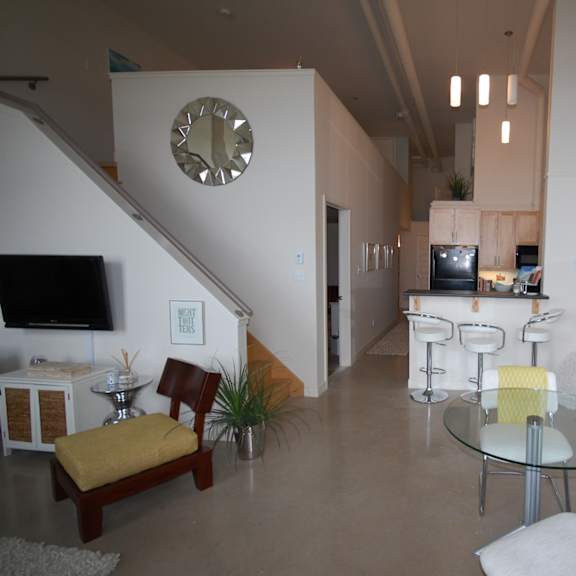 a living room with a glass table and chairs.