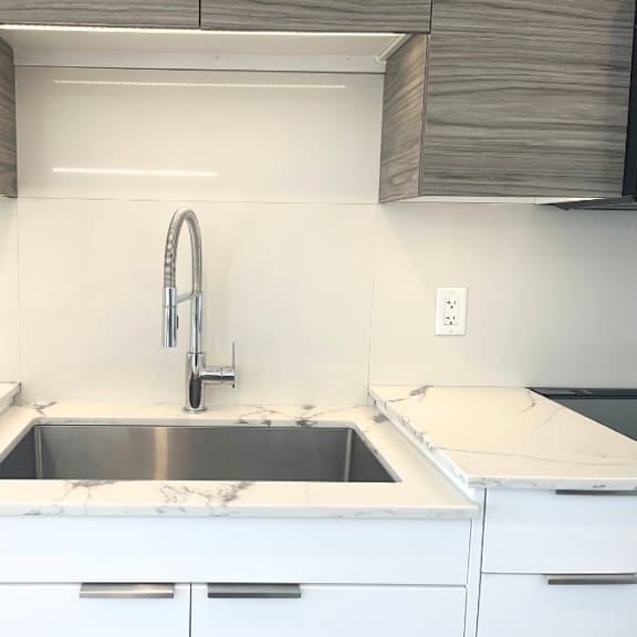 a kitchen with a sink and a refrigerator.