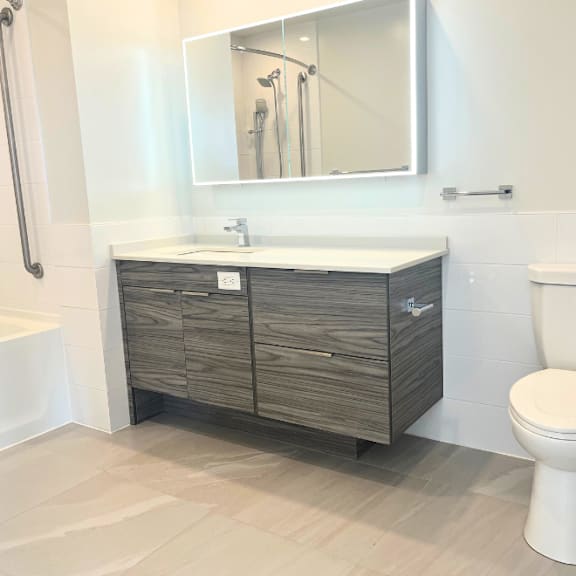 a white toilet sits next to a sink in a bathroom.