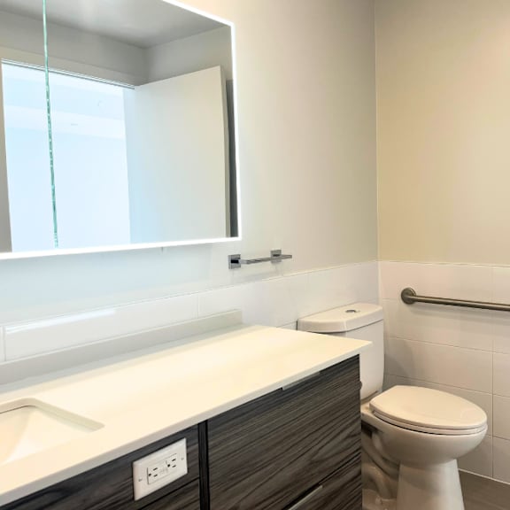 a white toilet sits next to a white sink in a bathroom.