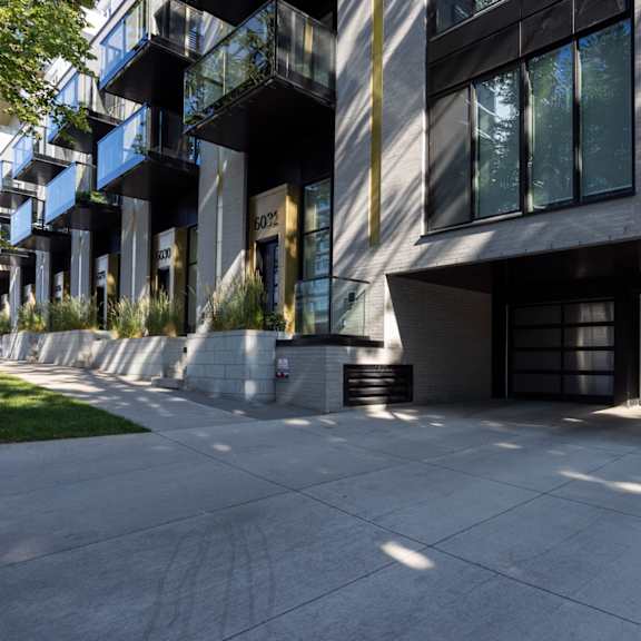 a modern building with a black and white facade and a large glass window.