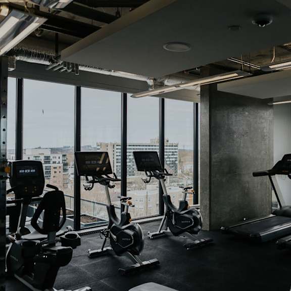 a gym with treadmills and exercise bikes.