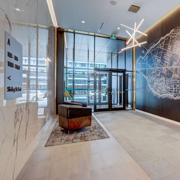 a hallway with a large wall mural and a bench.