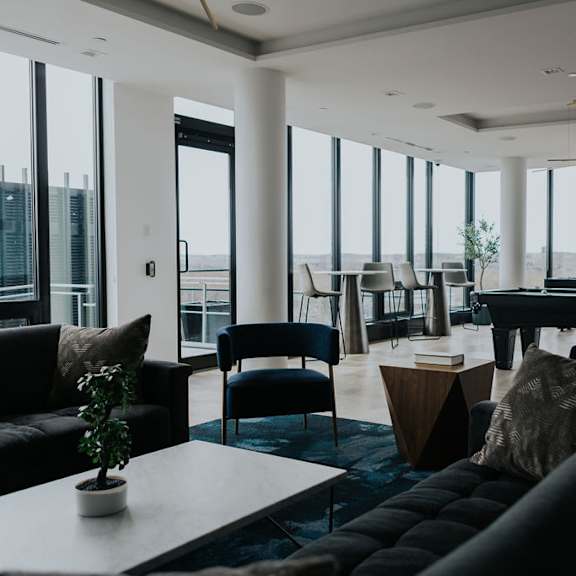a living room with a pool table and a view of the outside.