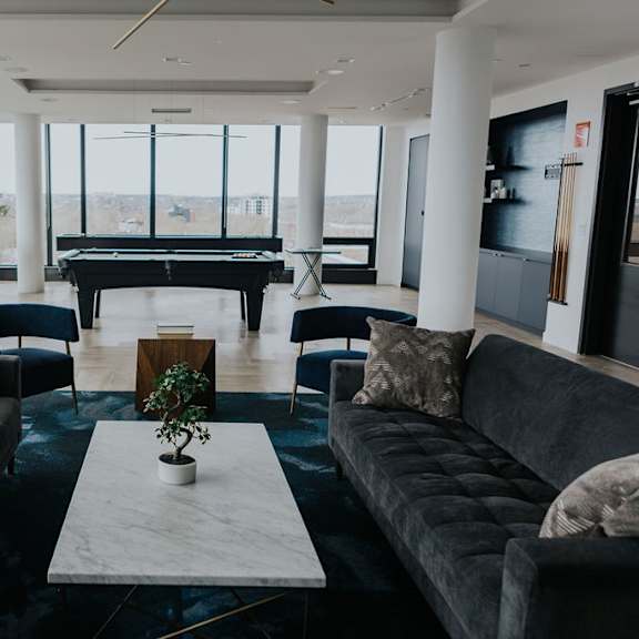 a living room with a piano and two couches.