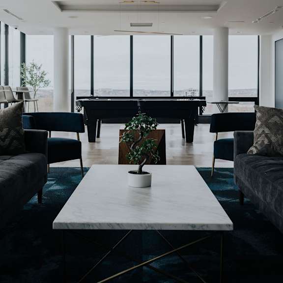 a living room with a piano and a view of the city.