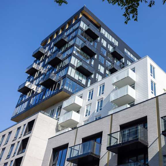 a modern building with a mix of blue and white balconies.