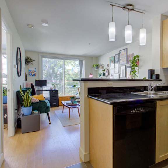 a kitchen with wooden cabinets and a black countertop.
