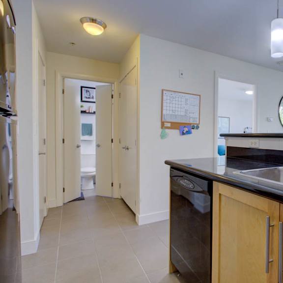 a kitchen with a sink, dishwasher, and refrigerator.
